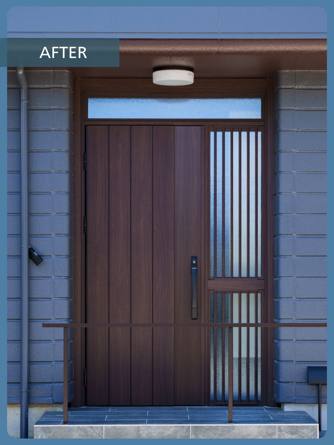 Front entry with a tall dark wood door and glass sidelights on the right, blue-gray brick exterior, and a metal railing; indicates an after-renovation result.